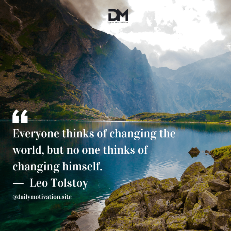 Light coming through clouds above calm blue lake and mountains.