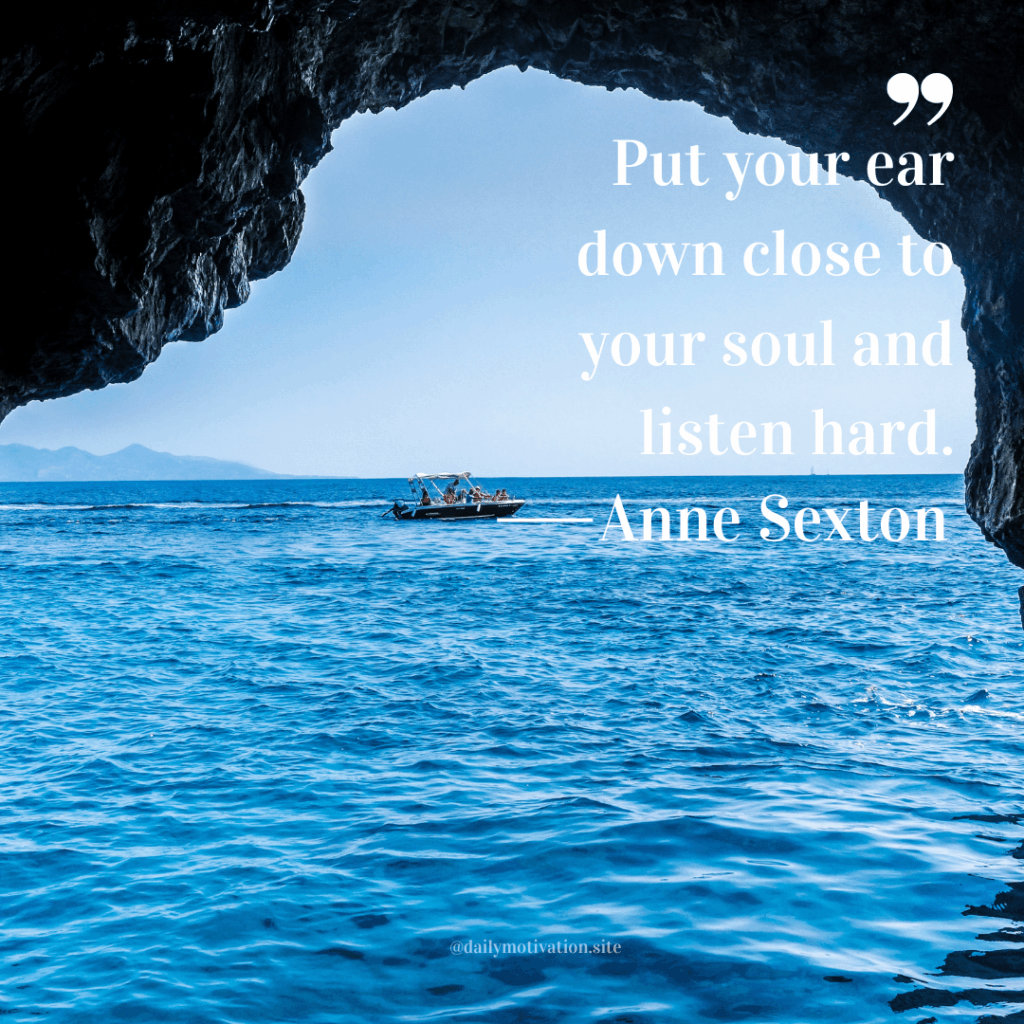 A view of a boat on the vast blue water from within the lip of a cave.