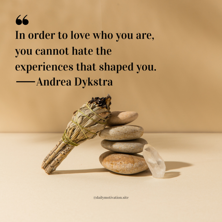 Sage bundle tied with string resting against a small stack of smooth stones on a warm beige background.
