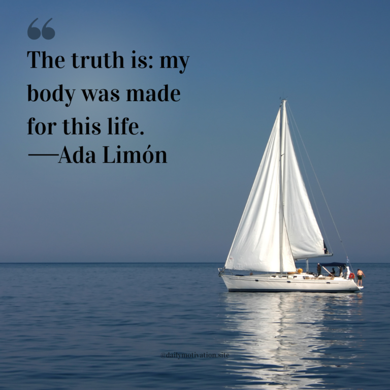 White sailboat floating on calm blue water beneath a clear sky.